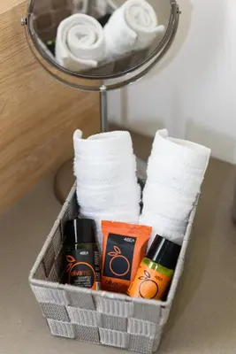a basket filled with toilet paper and toiletries at Casa Teresa | Near Sandy Beach in Chania Town