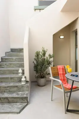 a stairway with a table and a chair and a table at Casa Teresa | Near Sandy Beach in Chania Town