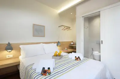 a bedroom with a bed with two toy blocks on it at Casa Teresa | Near Sandy Beach in Chania Town