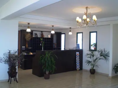 a lobby with potted plants and a reception desk at Roubini Apartments in Falasarna