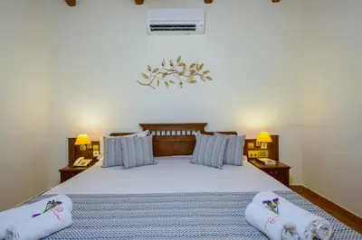 a bedroom with a bed with two pillows on it at Omega Platanias in Plataniás