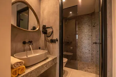 a bathroom with a sink and a shower at Omega Platanias in Plataniás