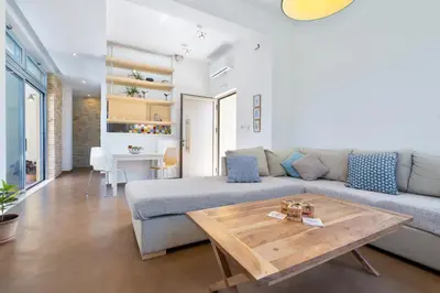 a living room with a couch and a table at Calma Seaside Villa in Kalyves
