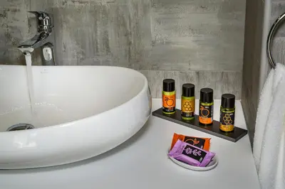 a bathroom sink with four bottles of essential oils on a counter at Platanias Villa Mirsini in Plataniás