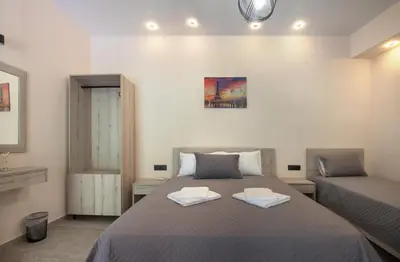 a bedroom with a bed with two towels on it at Antartisa B&B in Límni