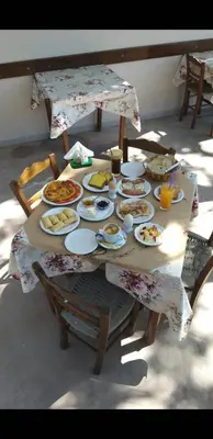 a table with plates of food on it at Antartisa B&B in Límni