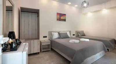 a bedroom with two beds and a television in it at Antartisa B&B in Límni
