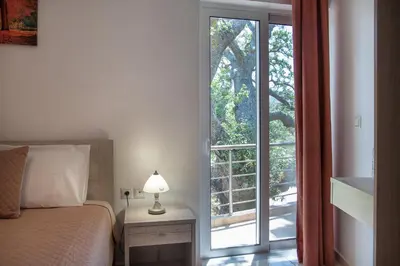 a bedroom with a bed and a large window at Antartisa B&B in Límni