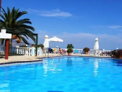 a large blue swimming pool in a resort at Antilia Apartments in Tavronitis