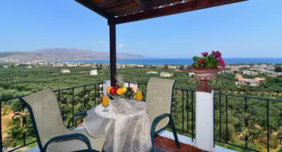 a table and chairs on a balcony with a view at Antilia Apartments in Tavronitis