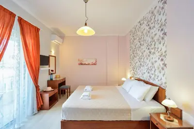 a hotel room with a bed and a window at Poseidon Apartments in Kato Daratso