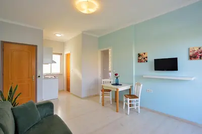 a living room with a couch and a table at Poseidon Apartments in Kato Daratso