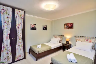 a bedroom with two beds and a window at Poseidon Apartments in Kato Daratso