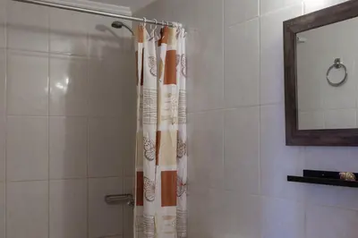 a shower with a shower curtain in a bathroom at Narkissos 'SUPERB' in Chania Town