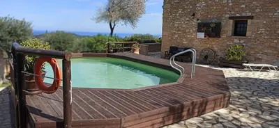 a small pool with a wooden deck and a wooden plunge poolvisor at Drys Villas in Xirokámbion