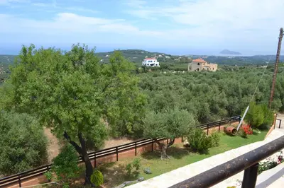 a view from the balcony of a house with trees at Drys Villas in Xirokámbion