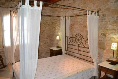 a bedroom with a bed with a metal canopy at Drys Villas in Xirokámbion
