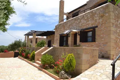 a brick house with flowers in front of it at Drys Villas in Xirokámbion