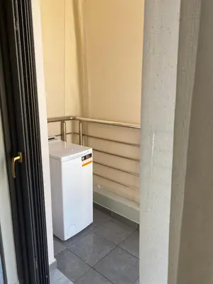 a small white refrigerator sitting in a room at Konstantina Apartment near the Beach in Chania Town