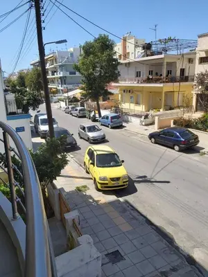 a yellow car parked on the side of a street at Konstantina Apartment near the Beach in Chania Town
