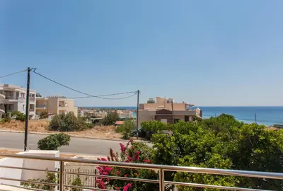 a balcony with a view of a street and the ocean at Paleochora Houses N2 in Palaiochóra