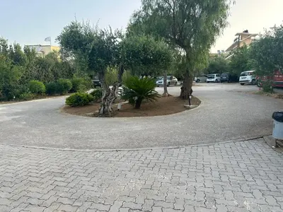 a parking lot with two trees in the middle at Rodon Hotel in Chania Town