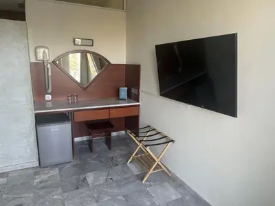 a room with a desk with a large television on the wall at Rodon Hotel in Chania Town
