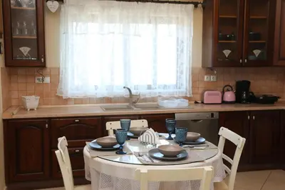 a kitchen with a table with chairs and a sink at Chrisas Apartment Chania in Chania Town
