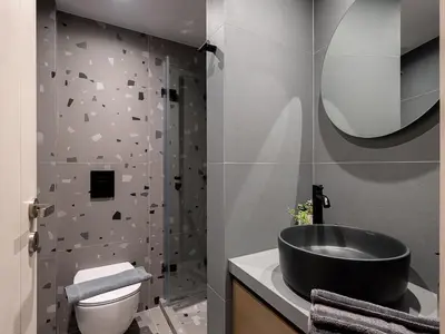 a bathroom with a black sink and a toilet at Vilia House on the Hill - Luxury Villa with Heated Pool near Chania in Chania Town