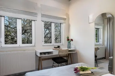 a bedroom with a desk and windows in a room at Vilia House on the Hill - Luxury Villa with Heated Pool near Chania in Chania Town