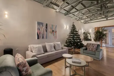 a living room with a couch and a christmas tree at Vilia House on the Hill - Luxury Villa with Heated Pool near Chania in Chania Town