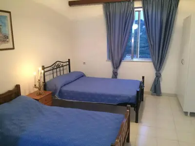 a bedroom with two beds and a window at House with Sea View close to Platanias in Vrísai