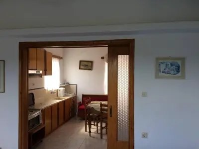 a kitchen and a dining room with a table and a kitchen at House with Sea View close to Platanias in Vrísai