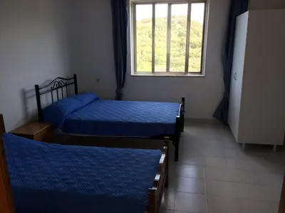 two beds in a room with a window at House with Sea View close to Platanias in Vrísai