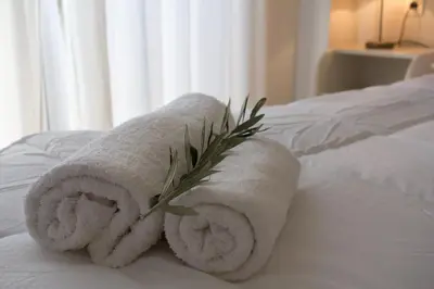 a couple of towels sitting on top of a bed at Like Home in Agia Marina Nea Kydonias
