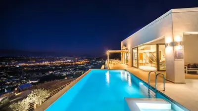 a house with a swimming pool at night at Villa Con Vista- Heated Pool 4 bdr sleeps 8 in Tsikalariá