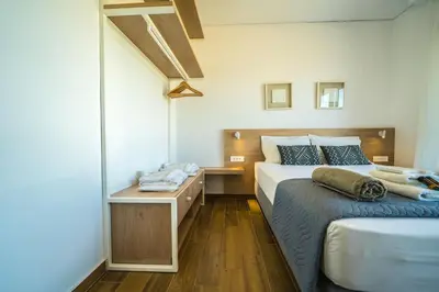 a bedroom with two beds and a mirror at Villa Con Vista- Heated Pool 4 bdr sleeps 8 in Tsikalariá