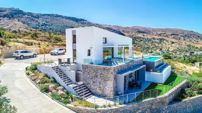 a house on the side of a mountain at Villa Con Vista- Heated Pool 4 bdr sleeps 8 in Tsikalariá