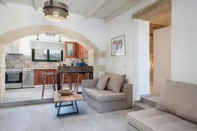 a living room with a couch and a table at Trialonia Luxury Villa in Kissamos