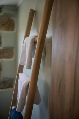 a ladder with towels on it in a bathroom at Trialonia Luxury Villa in Kissamos