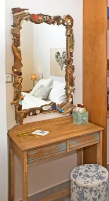 a bedroom with a bed with a mirror on a table at Arodamos Studios & Apts in Kissamos