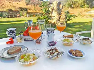 a table with plates of food and glasses of wine at Arodamos Studios & Apts in Kissamos