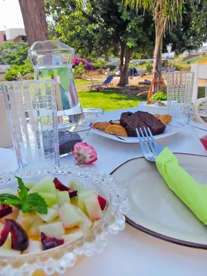 a white table with plates of food on it at Arodamos Studios & Apts in Kissamos