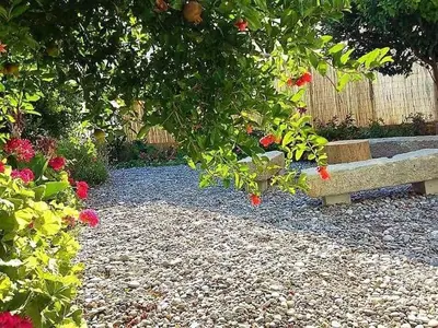 a bench in a garden with flowers and a fence at Terra Falasarna in Falasarna