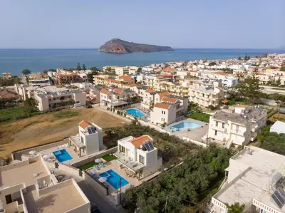 an aerial view of a city and the ocean at Villa Kambos Platanias in Plataniás