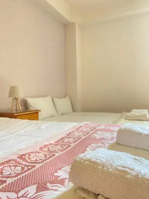 a bedroom with a bed with a red and white blanket at Villa Pandora - Petit Bonheur in Maleme