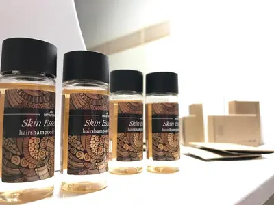 three bottles of essential oils sitting on a counter at Omega Comfy Apartments in Almirida
