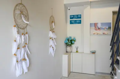 a room with a white wall with white towels on the wall at Aequor Luxury Rooms & Apartments in Kato Daratso