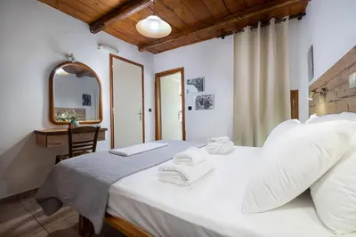 a bedroom with a white bed with towels on it at Topolia 1 Bedroom Villa in Topólia