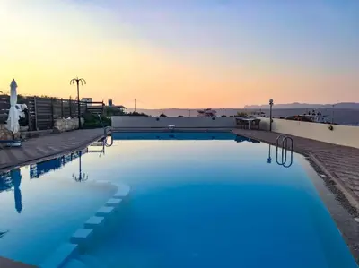 a large swimming pool with blue water on top of a building at Kalithea Studio Aptera in Megála Khoráfia